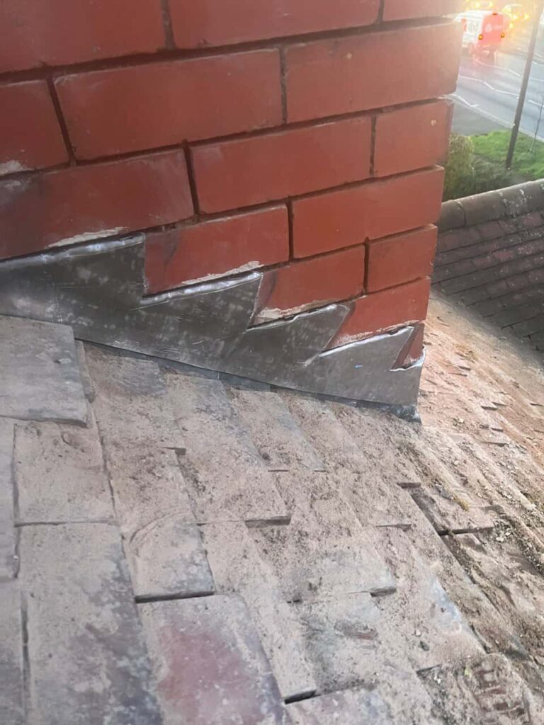This is a photo of new leadwork being installed around an old chimney. Works carried out by Liphook Roofing Repairs